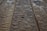 Drops of water scattered across a wooden surface, highlighting the wood grain texture. The surface appears wet with varying sizes of water droplets.