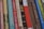 A collection of classic books with various titles lined up vertically, showcasing their colorful and patterned spines. Each spine features unique typography and designs, indicating a mix of genres and authors.
