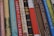 A collection of classic books with various titles lined up vertically, showcasing their colorful and patterned spines. Each spine features unique typography and designs, indicating a mix of genres and authors.