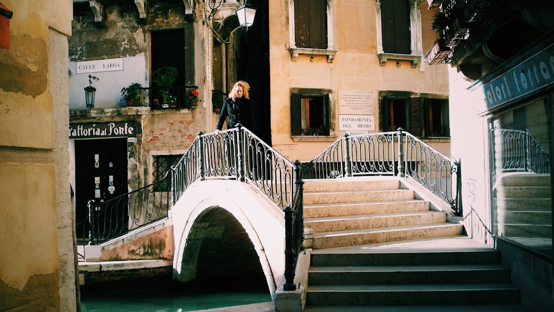 woman standing near railings beside concrete stairs
