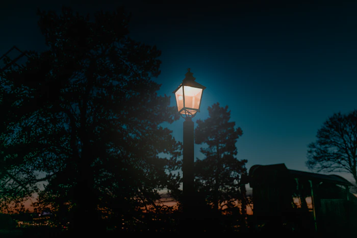 Warm lantern post glowing at night