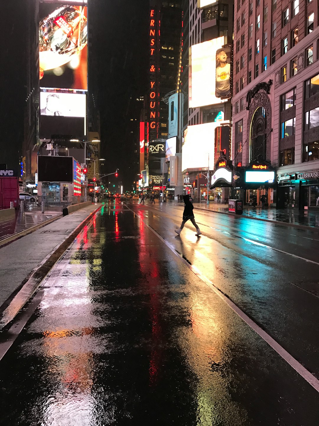 black concrete road near high buildings at nighttime