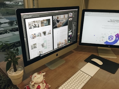 a desk with two computer monitors and a keyboard