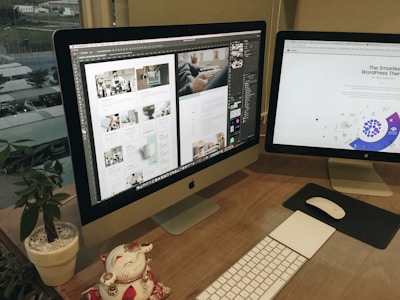 a desk with two computer monitors and a keyboard