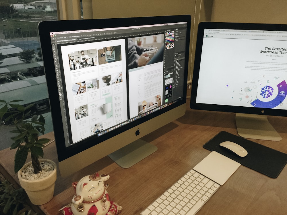 a desk with two computer monitors and a keyboard