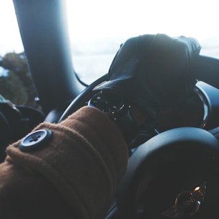 person holding black steering wheel
