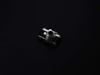 A sleek, elegant film camera set against a minimalist dark background, symbolizing refined audiovisual craftsmanship.