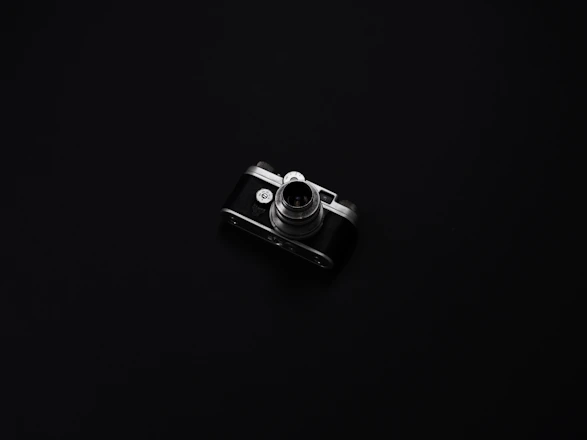 Elegant photo of a camera on a dark luxury background with golden accents.