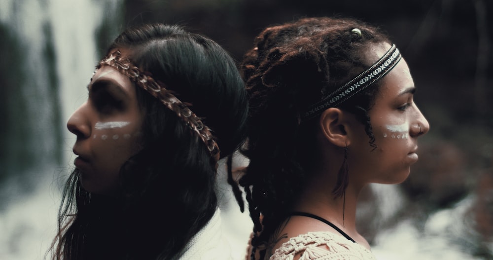 closeup photo of two women wearing headbands