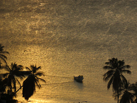 A serene pastel-hued boat gently floating on calm Florida inshore waters at sunrise.