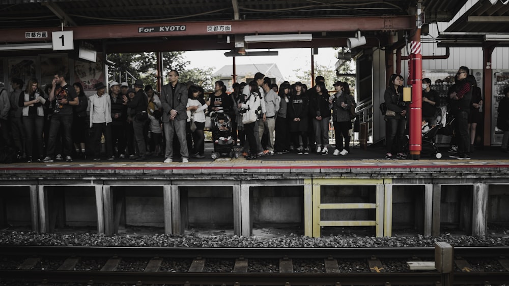 people standing in train station