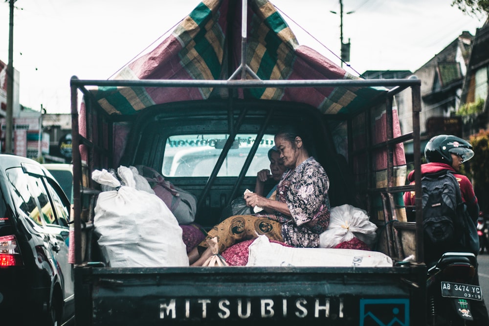 woman seating on drop side truck