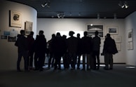 A group of people contemplating a piece of modern art in a gallery.