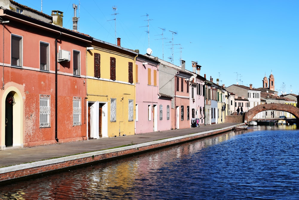 maisons peintes de couleurs assorties à côté d’un plan d’eau'