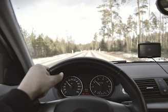 Close-up of a Rexa truck driver checking the GPS device inside the vehicle.