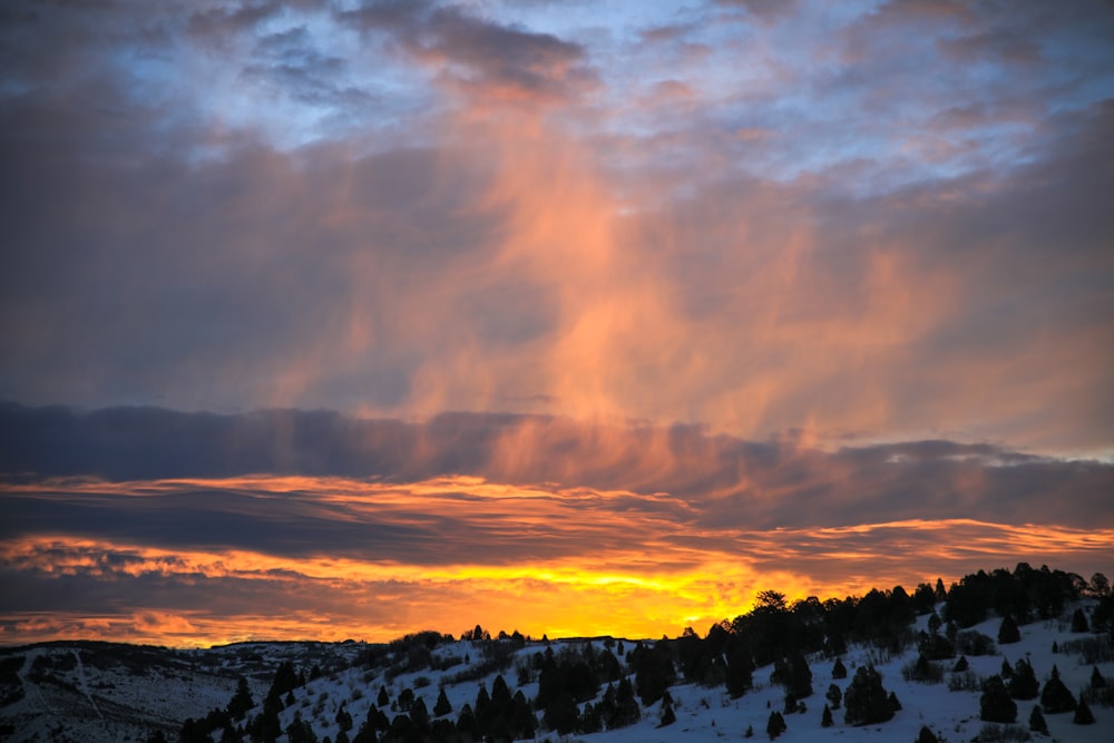 mountain with snow during sunset