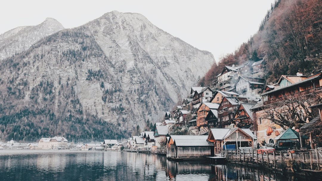 photography of house beside body of water, Quaint mountain village over a lake