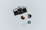 black Canon film camera with two films in flat lay photography