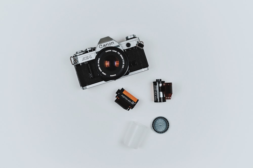 black Canon film camera with two films in flat lay photography