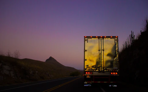Delivery truck loaded with iron products ready to depart at sunset.