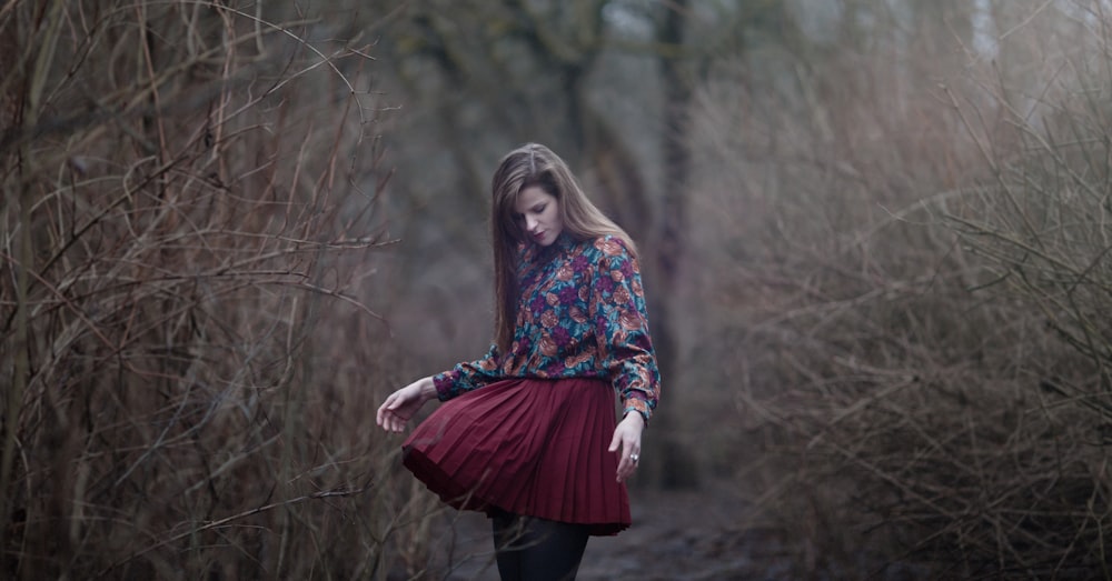 woman standing in between grass fields