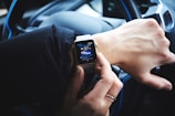 person holding gold aluminum Apple Watch