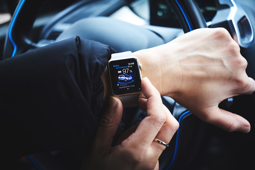 person holding gold aluminum Apple Watch, Driver with an Apple Watch