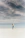 woman looking up to the sky while standing on white sand