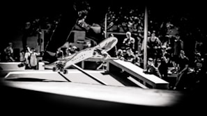Dynamic shot of a skateboarder performing a trick in a skate park.