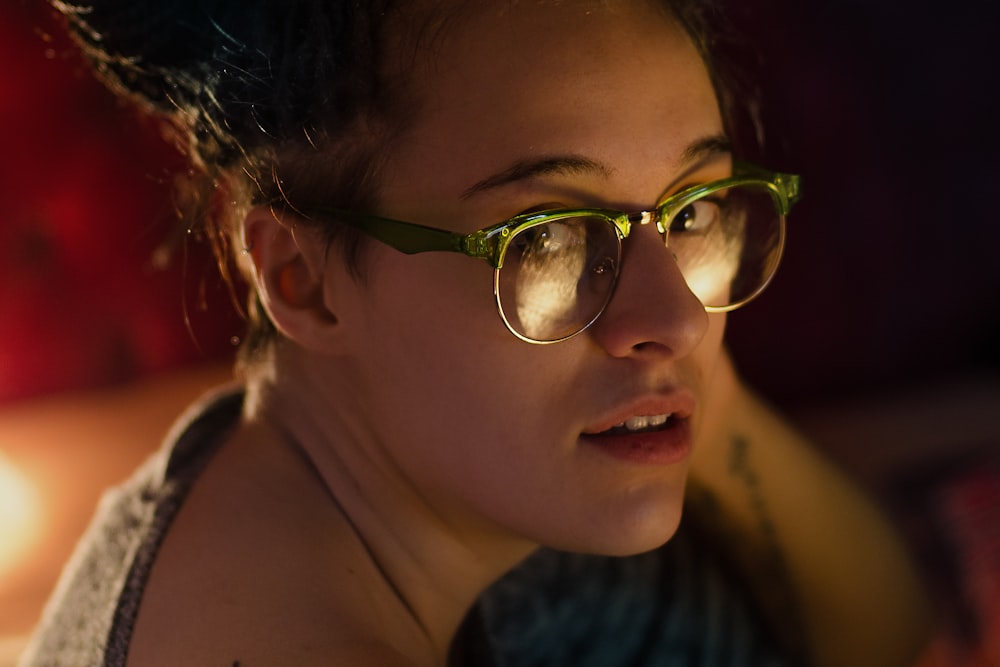 close up photography of woman wearing eyeglasses