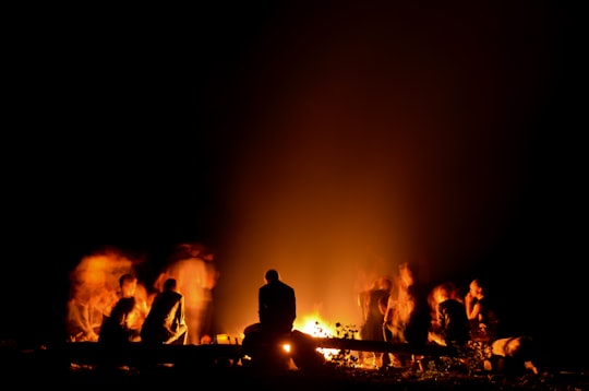 people gathered around camp fire at nighttime in Entrevaux France