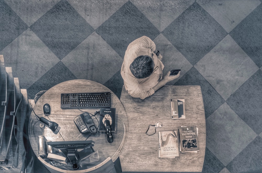 top-view photography of man near computer set