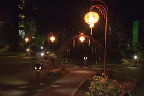 Solar LED pathway lights illuminating a garden walkway at dusk with a warm, inviting glow.