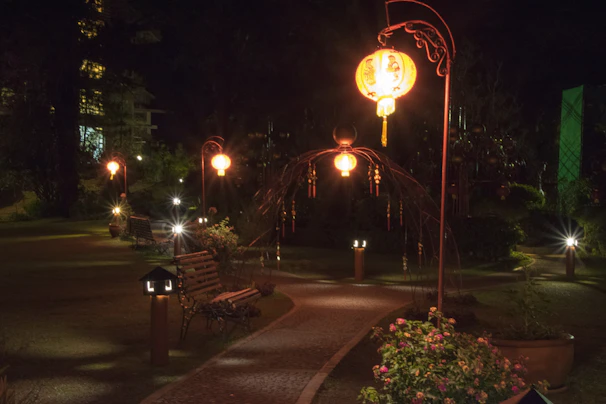 A cozy garden pathway softly lit by warm solar lanterns at dusk.