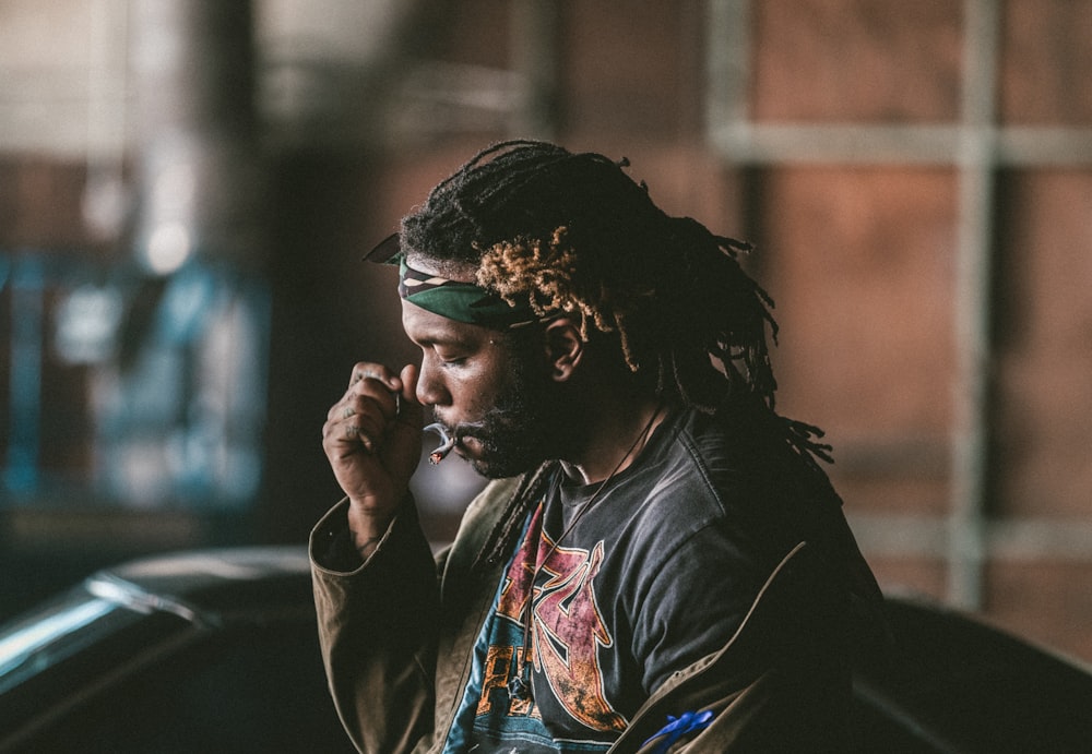 man sitting smoking cigarette