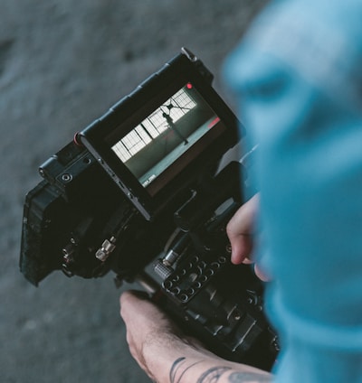 person holding black DSLR camera