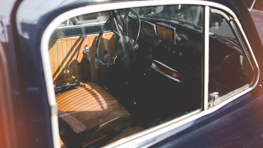 close photo of brown and black vehicle indoor, vintage car interior window