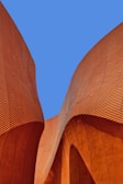minimalist photography of brown wavy structure