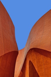 minimalist photography of brown wavy structure