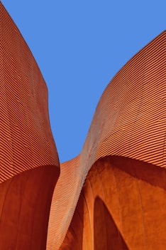 minimalist photography of brown wavy structure