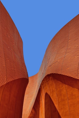 minimalist photography of brown wavy structure