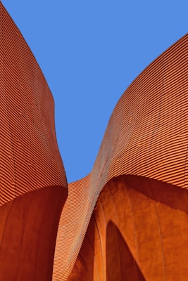 minimalist photography of brown wavy structure