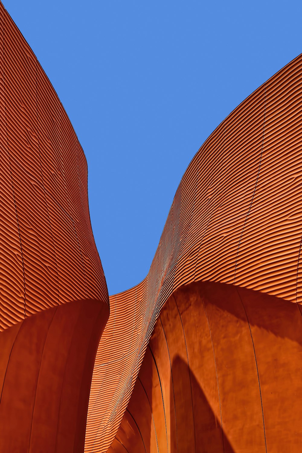 minimalist photography of brown wavy structure