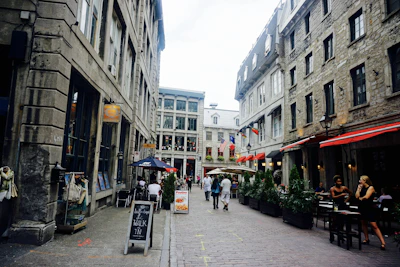 Historic cobblestone street lined with charming cafes and flowering balconies.
