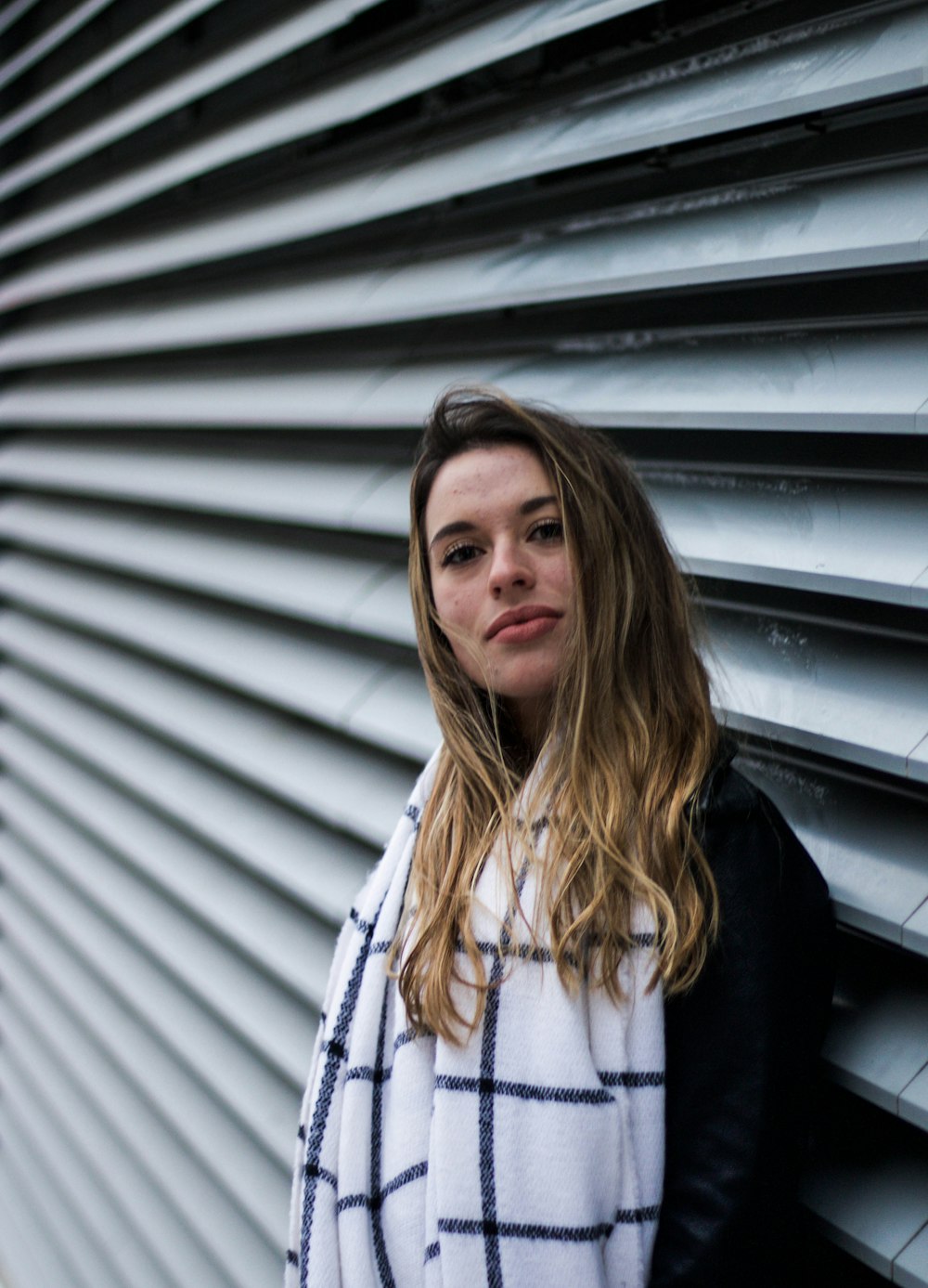 woman leaning on wall