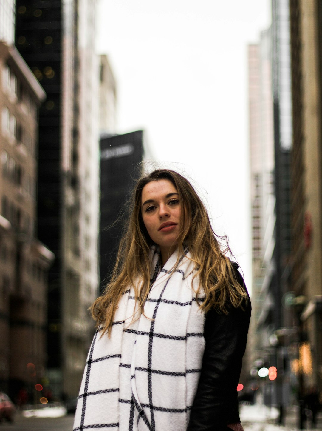 women's wearing black and white plaid scarf