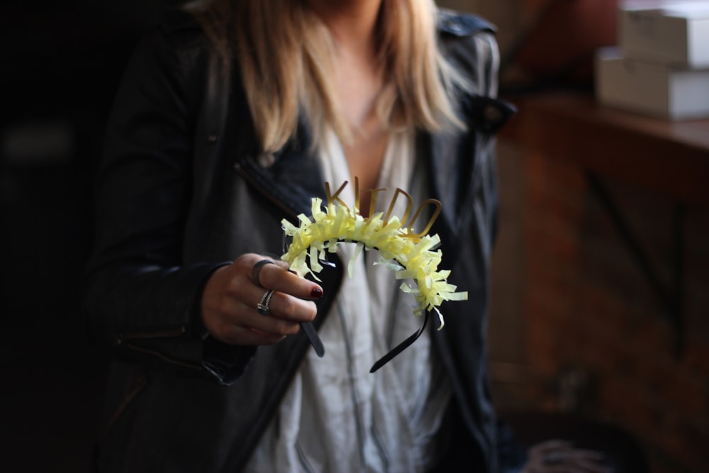 person holding green and black headband