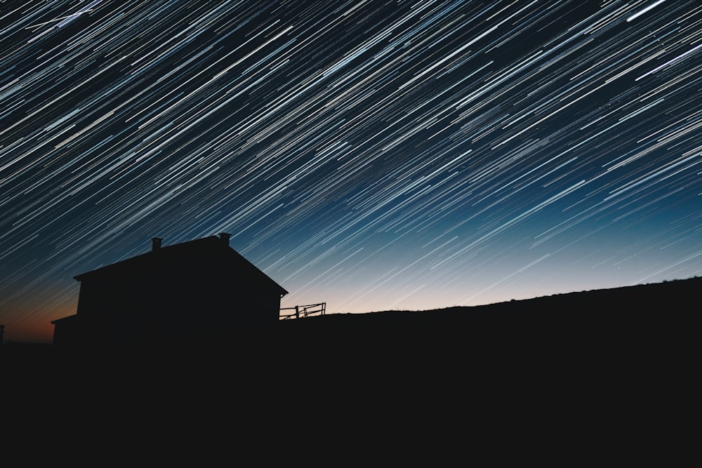 time-lapse photography of house silhouette at night
