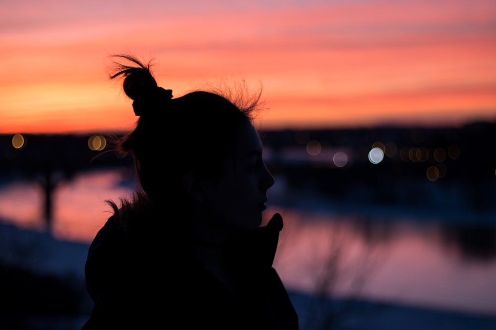 silhouette of woman near bodies of water