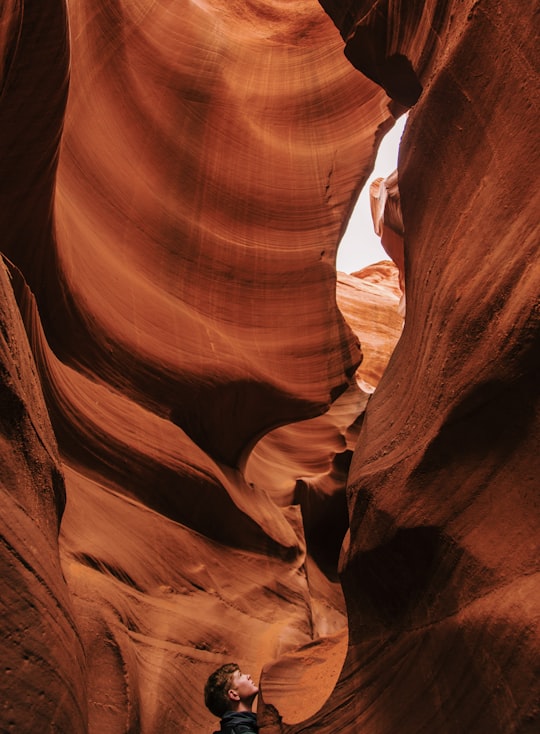 man standing inside cave in Antelope Canyon United States